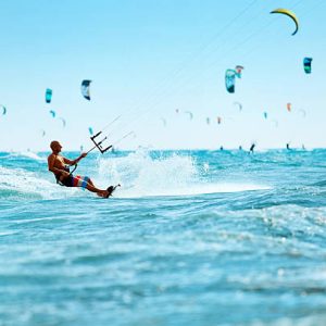 Kiteboarding, Kitesurfing. Water Sports. Professional Kite Surfer In Action On Waves In Ocean. Extreme Sport. Healthy Active Lifestyle. Hobby. Recreational Sporting Activity. Summer Fun, Adventure